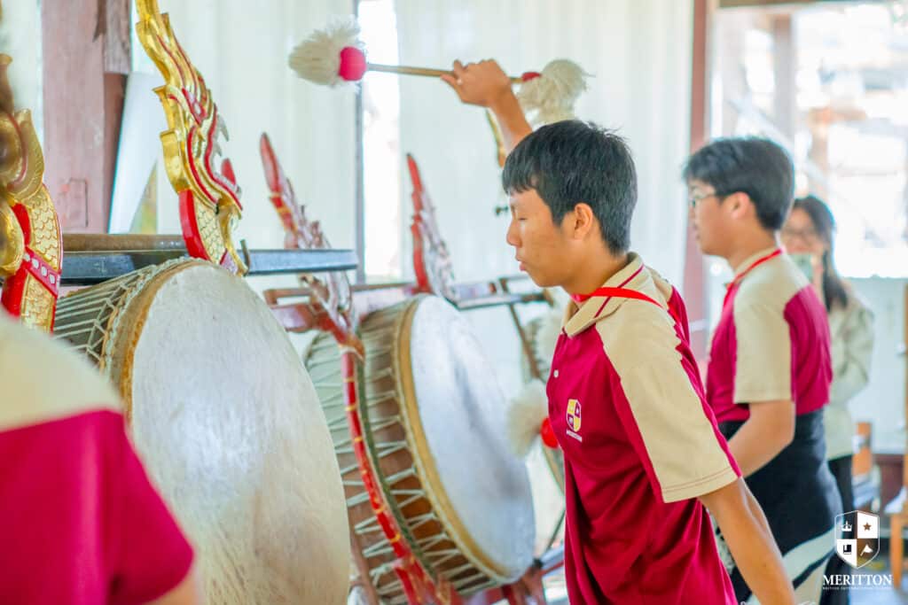 Student hitting Drum